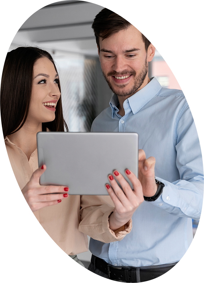 a man and woman looking at a tablet